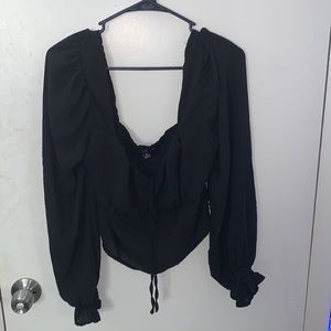 Cropped black sheer shirt.